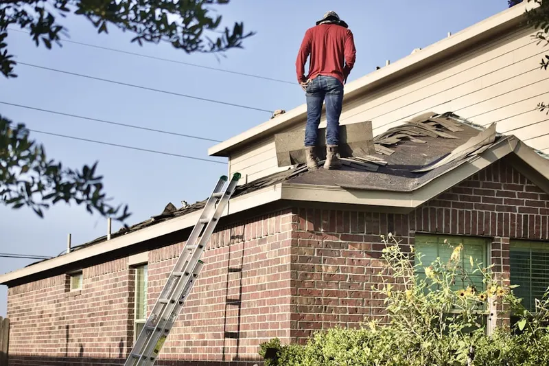 Professional roofer working on a residential roof in Guajome